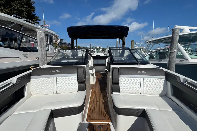 Slide: The Image of 2017 Sea Ray SLX 310 Outboard boat with luxurious seating and sleek design at a marina. - 28