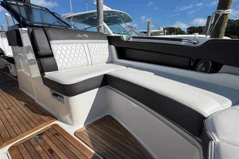Slide: The Image of 2017 Sea Ray SLX 310 Outboard boat interior with luxurious seating and teak flooring. - 32
