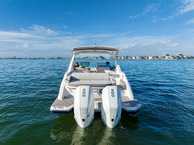 Slide: The Image of 2017 Sea Ray SLX 310 Outboard boat interior with sleek design and wooden flooring. - 40
