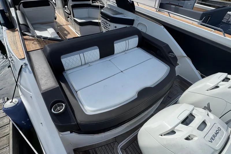 Slide: The Image of 2017 Sea Ray SLX 310 Outboard boat with spacious seating and dual outboard engines. - 9