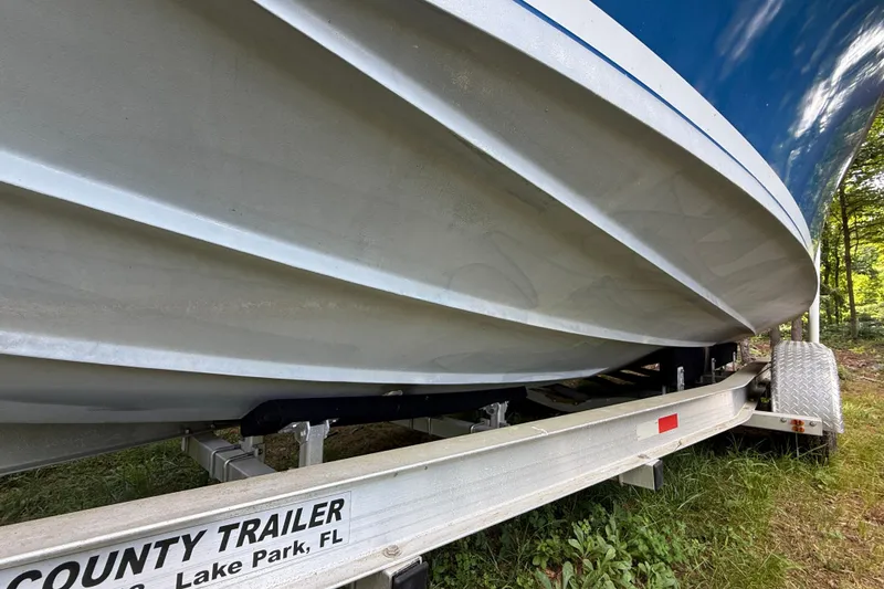 Slide: The Image of 1965 Bertram boat on trailer, Lake Park, FL, side view. - 14