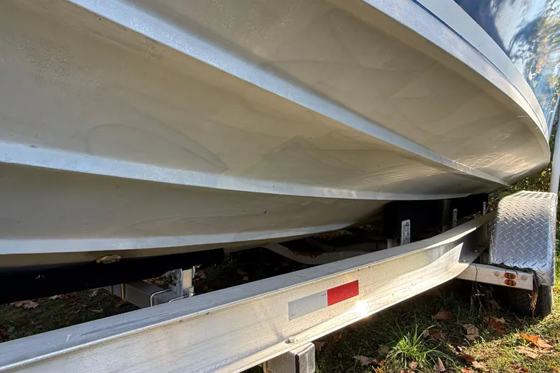 Slide: The Image of 1965 Bertram boat hull on trailer, showcasing sleek design and sturdy construction. - 19