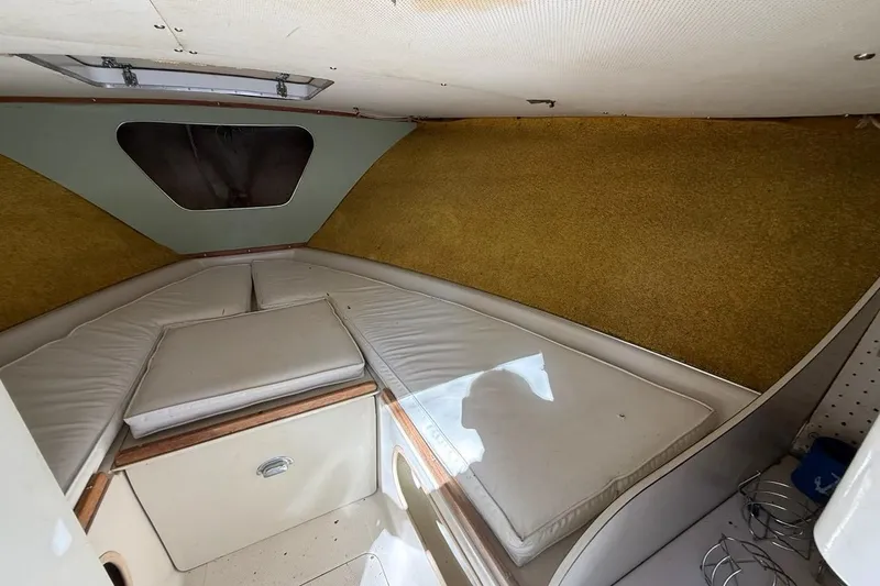 Slide: The Image of Interior cabin of a 1965 Bertram boat with cushioned seating and storage. - 35