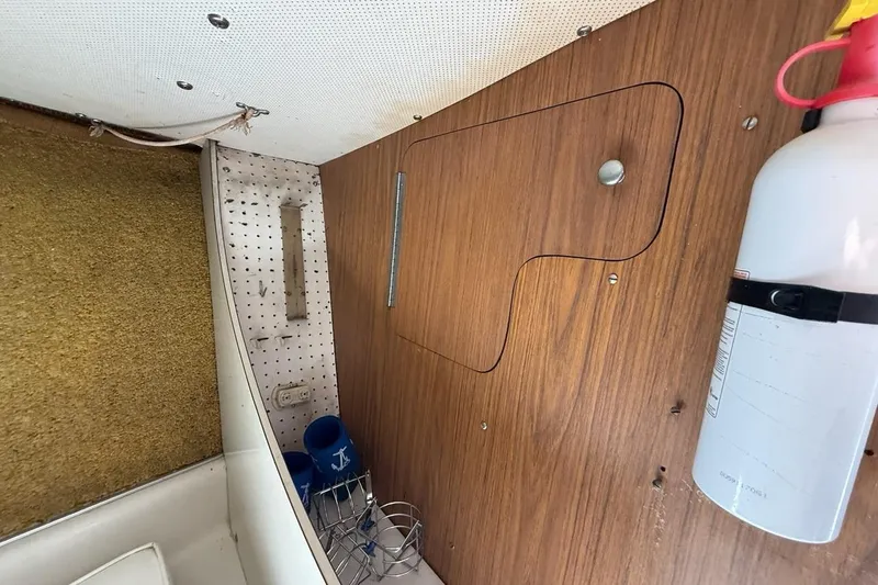 Slide: The Image of Interior of a 1965 Bertram boat with wood paneling and fire extinguisher. - 36