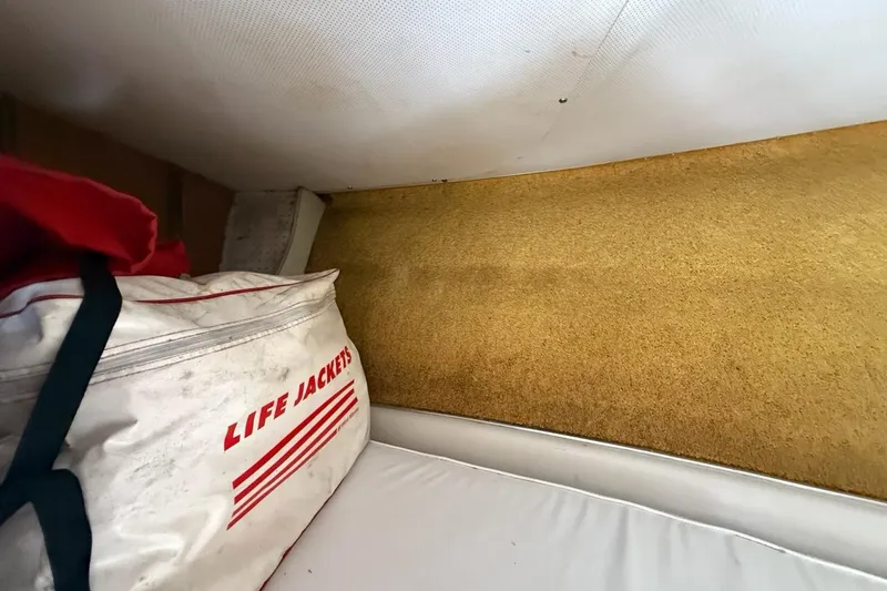 Slide: The Image of Interior of a 1965 Bertram boat with life jackets stored in a white bag. - 37