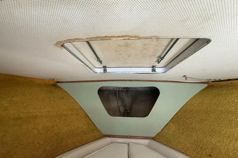 Slide: The Image of Interior of a 1965 Bertram boat showing a ceiling hatch and vintage design. - 38