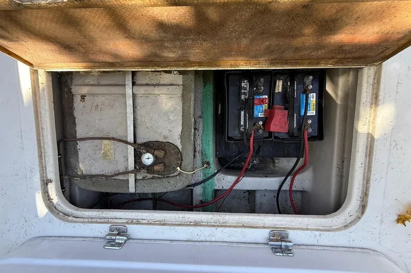 Slide: The Image of 1965 Bertram boat battery compartment with wiring and connections visible. - 40
