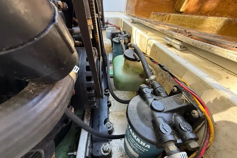 Slide: The Image of 1965 Bertram engine compartment with Yamaha filter and visible wiring. - 54