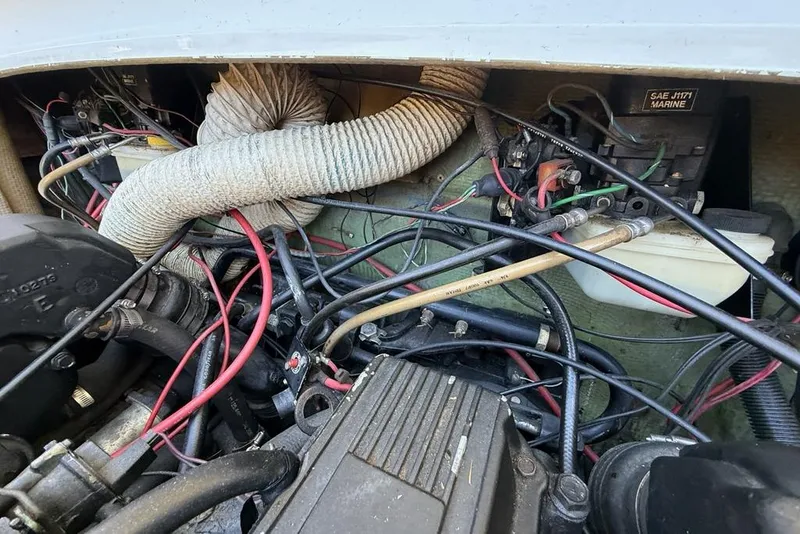 Slide: The Image of 1965 Bertram engine compartment with wiring and components, showcasing marine engineering details. - 55