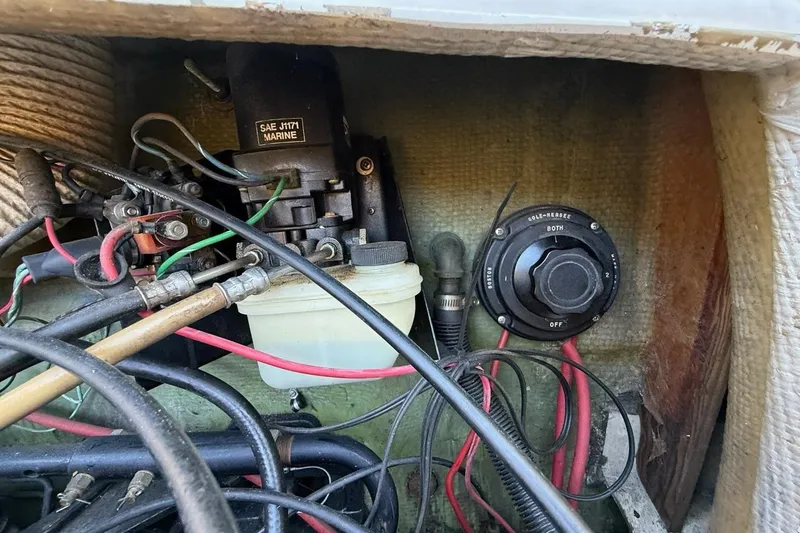 Slide: The Image of 1965 Bertram boat electrical system with wires and marine components. - 56