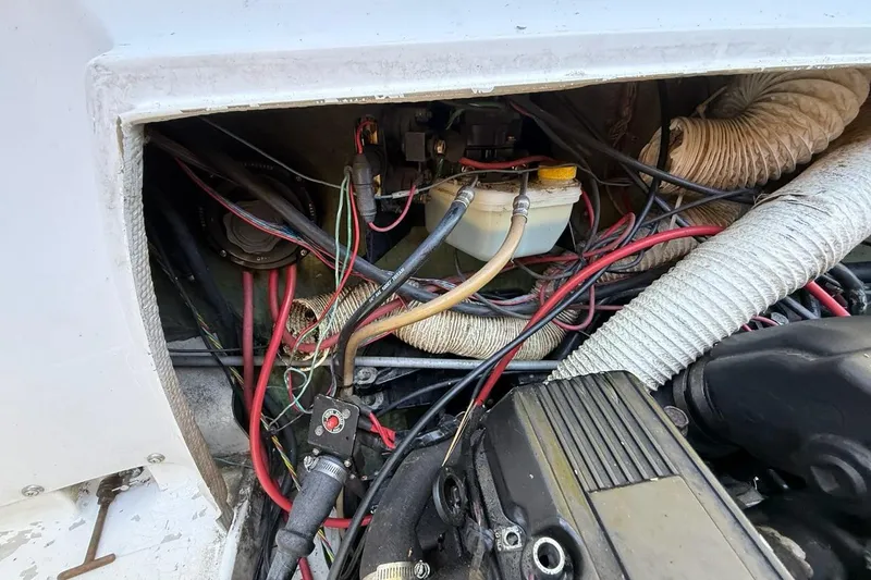 Slide: The Image of Engine compartment of a 1965 Bertram boat with visible wiring and components. - 60