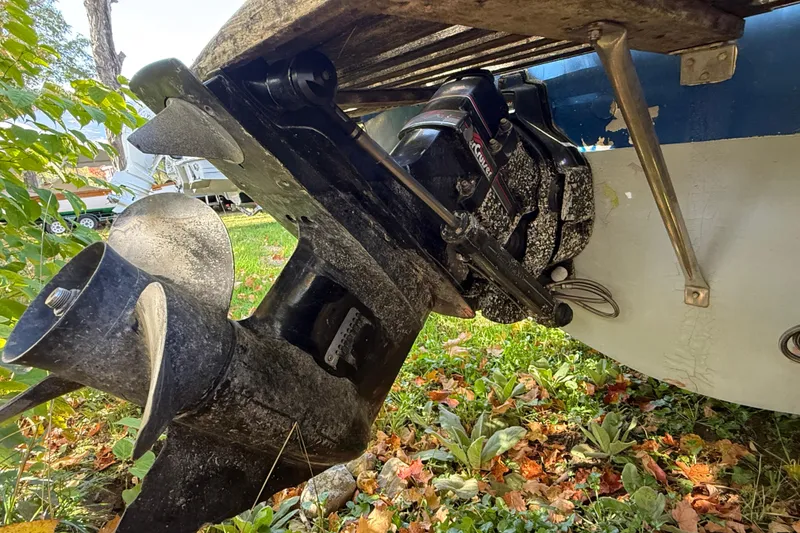 Slide: The Image of 1965 Bertram boat stern drive and propeller on grassy ground with autumn leaves. - 63