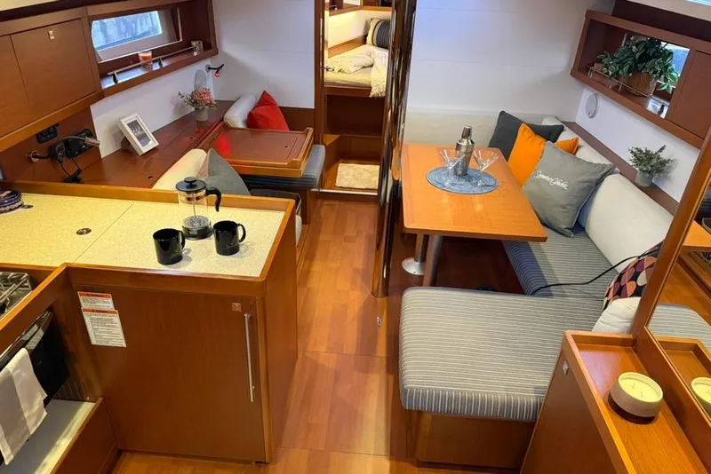 Slide: The Image of Interior of 2014 Beneteau Oceanis 41 yacht with cozy seating and dining area. - 1
