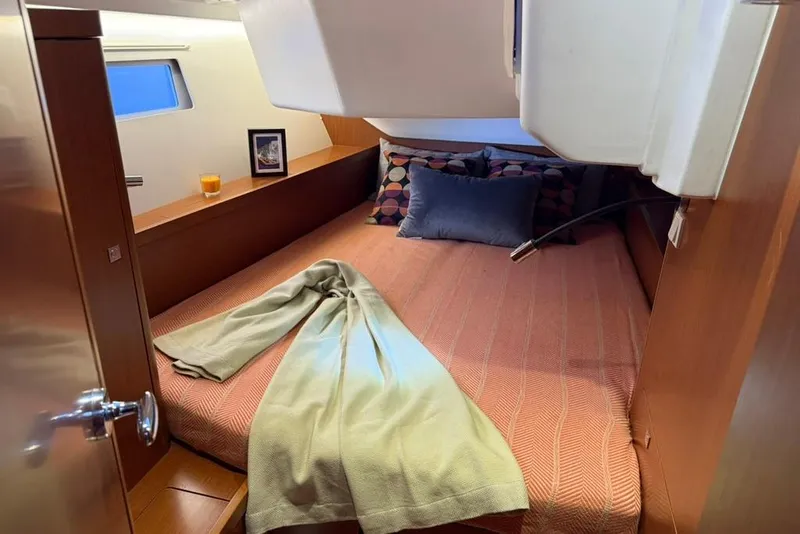 Slide: The Image of Cozy cabin interior of 2014 Beneteau Oceanis 41 sailboat with bed and decor. - 10
