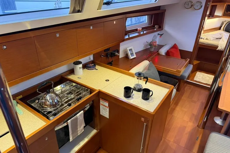Slide: The Image of Interior of 2014 Beneteau Oceanis 41 yacht with modern kitchen and cozy seating area. - 12