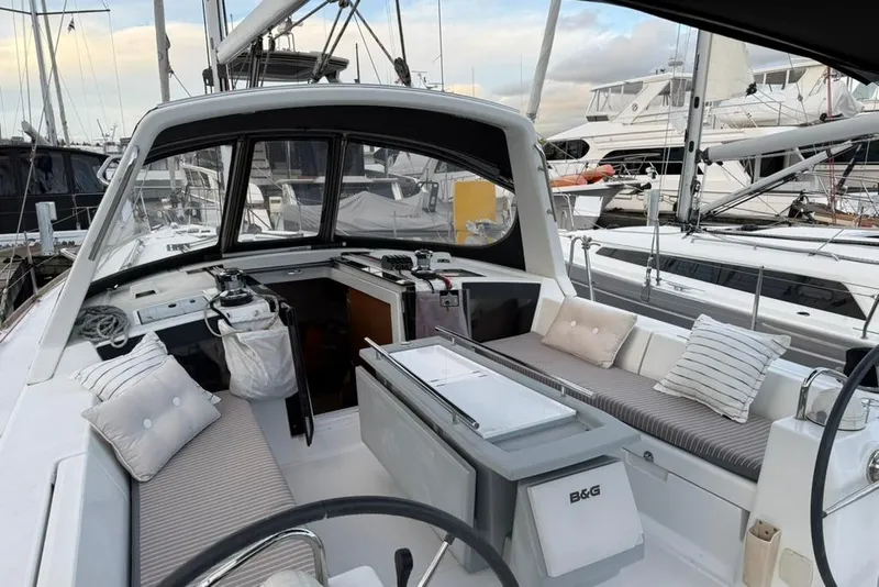 Slide: The Image of 2014 Beneteau Oceanis 41 sailboat cockpit with cushions, docked in marina. - 26