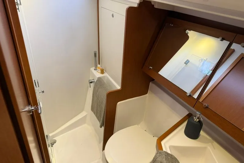 Slide: The Image of 2014 Beneteau Oceanis 41 yacht bathroom with wooden cabinetry and modern fixtures. - 6
