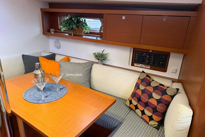 Slide: The Image of Interior of 2014 Beneteau Oceanis 41 yacht with cozy dining area and stylish decor. - 8