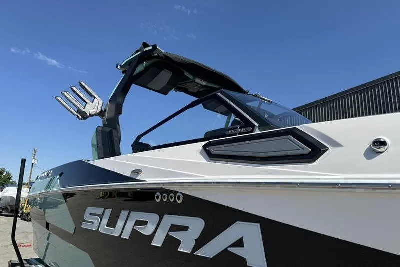 Slide: The Image of 2024 Supra SE 575 boat with sleek design and modern features under clear blue sky. - 3