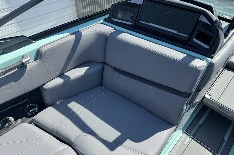 Slide: The Image of 2024 Supra SE 575 boat interior with gray seating and modern dashboard. - 8
