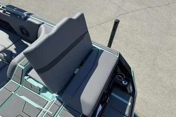 Slide: The Image of 2024 Supra SE 575 boat interior with gray seating and cup holders. - 9