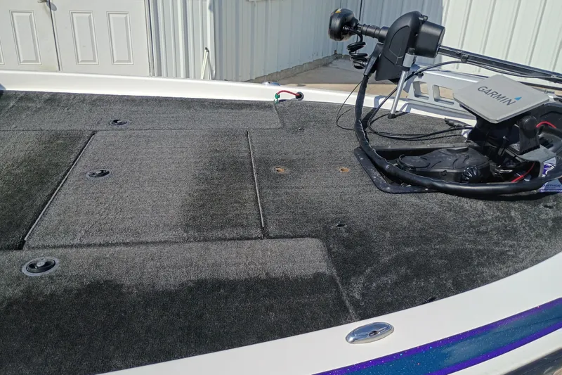 Slide: The Image of 2003 Skeeter TZX190 boat deck with Garmin trolling motor, featuring carpeted surface. - 7