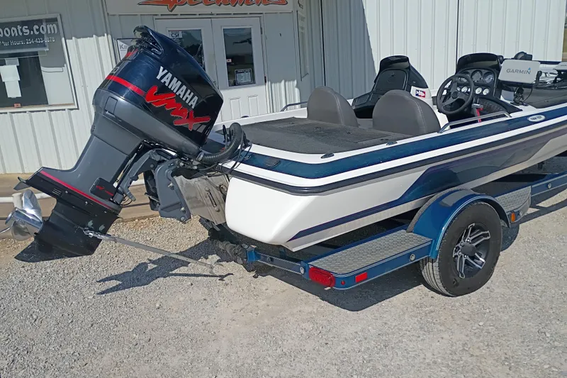 Slide: The Image of 2003 Skeeter TZX190 boat with Yamaha VMAX engine on trailer, parked outside a building. - 8