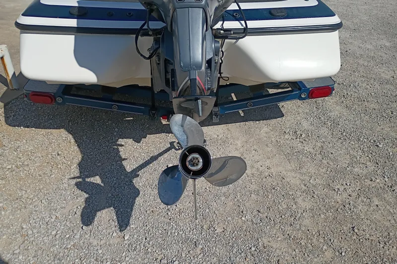 Slide: The Image of 2003 Skeeter TZX190 boat propeller and motor on gravel surface. - 9