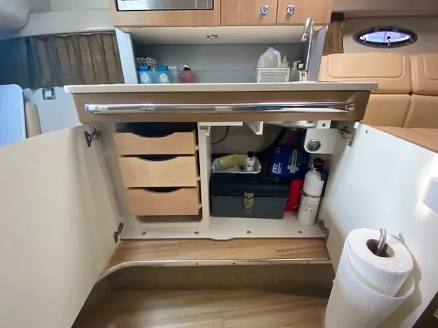 Slide: The Image of 2012 Formula 350 Sun Sport interior kitchen with open cabinets and storage. - 14