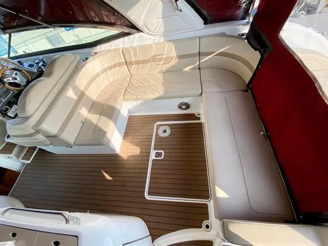 Slide: The Image of 2012 Formula 350 Sun Sport boat interior with beige seating and wood-style flooring. - 36