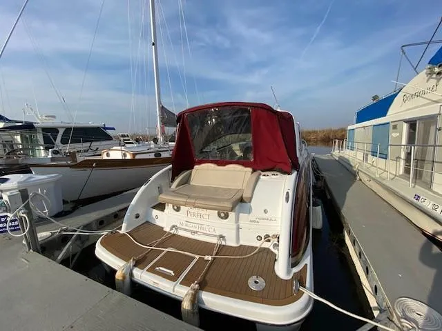 Slide: The Image of 2012 Formula 350 Sun Sport boat docked with red canopy and wooden deck. - 38