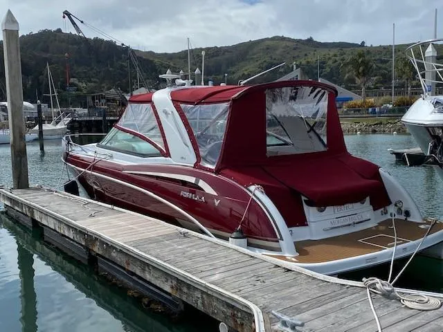 Slide: The Image of 2012 Formula 350 Sun Sport boat docked in marina with red canopy. - 40