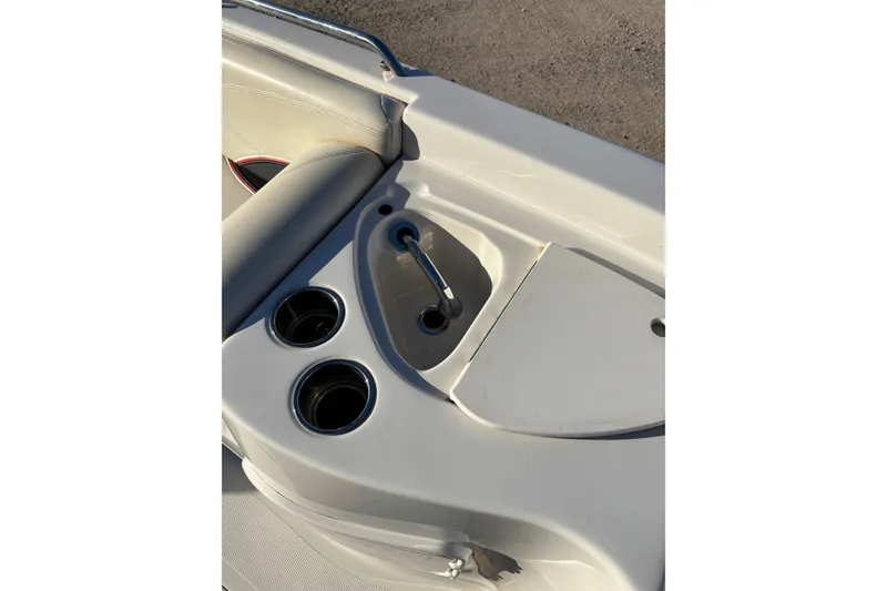 Slide: The Image of 2014 Tahoe 215 Xi boat interior with cup holders and storage compartment. - 14
