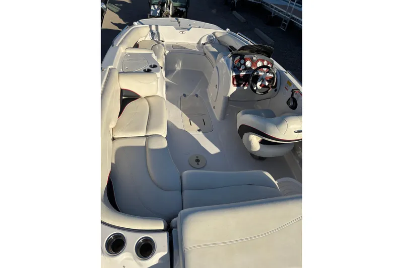 Slide: The Image of 2014 Tahoe 215 Xi boat interior with plush seating and modern dashboard. - 15