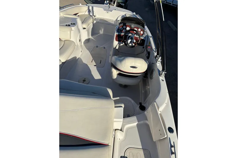 Slide: The Image of 2014 Tahoe 215 Xi boat interior with steering wheel and seating area. - 16