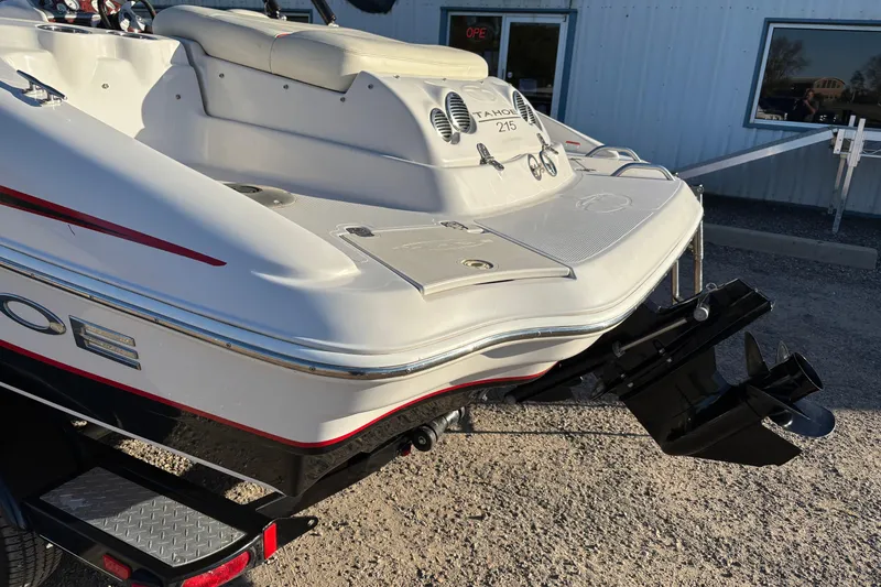 Slide: The Image of 2014 Tahoe 215 Xi boat rear view with outboard motor and seating. - 17
