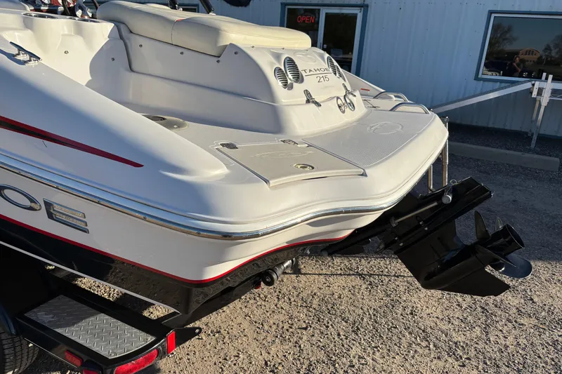 Slide: The Image of 2014 Tahoe 215 Xi boat rear view with outboard motor and seating. - 18