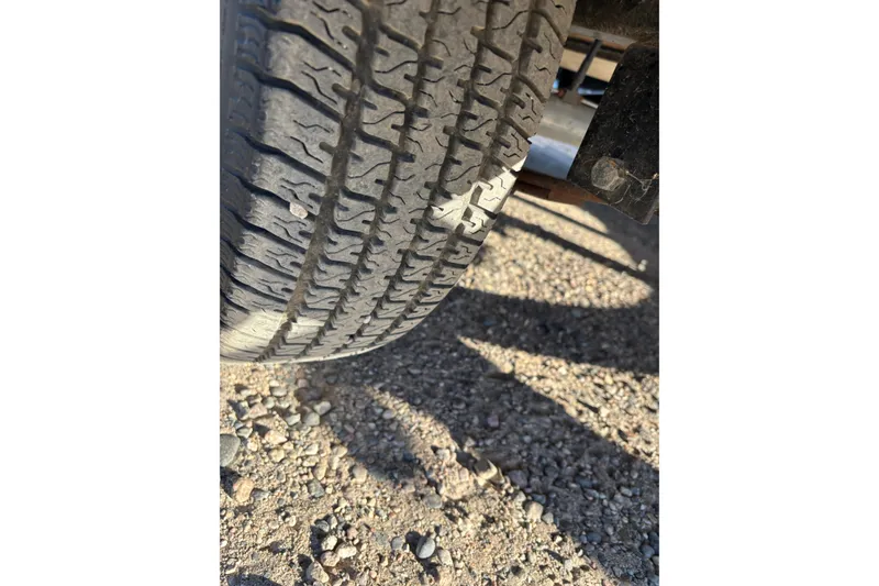 Slide: The Image of Close-up of a 2014 Tahoe 215 Xi tire on gravel surface. - 19