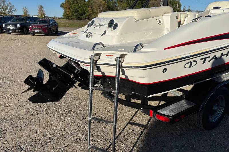 Slide: The Image of 2014 Tahoe 215 Xi boat on trailer with ladder and outboard motor. - 5