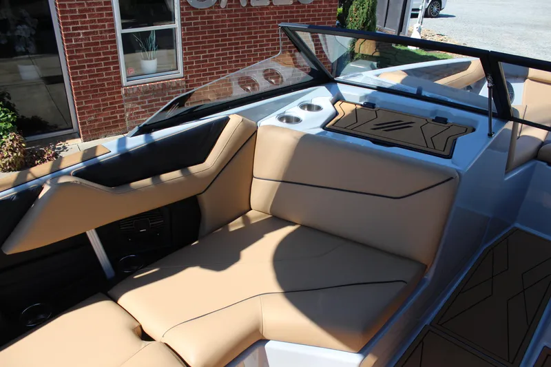 Slide: The Image of 2026 ATX Surf Boats 22 Type-S interior with tan seating and cup holders. - 12