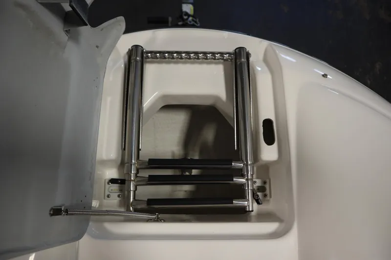 Slide: The Image of Yamaha 210 SX 2010 boat ladder, stainless steel, folded on white deck. - 13