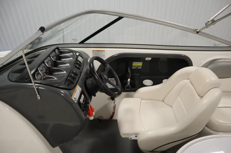 Slide: The Image of 2010 Yamaha 210 SX boat interior with steering wheel and dashboard controls. - 18