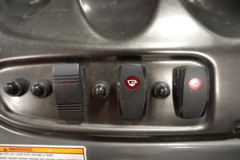 Slide: The Image of Control panel of a 2010 Yamaha 210 SX boat with switches and warning label. - 22