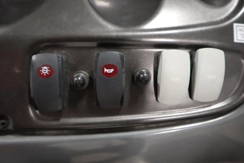 Slide: The Image of Dashboard switches on a 2010 Yamaha 210 SX boat. - 23