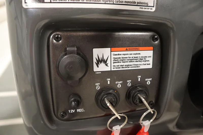 Slide: The Image of Control panel of a 2010 Yamaha 210 SX boat with warning label and ignition keys. - 24