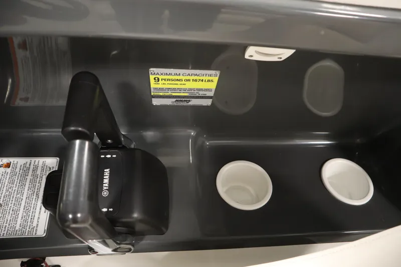 Slide: The Image of Interior of 2010 Yamaha 210 SX boat with control lever and cup holders. - 26