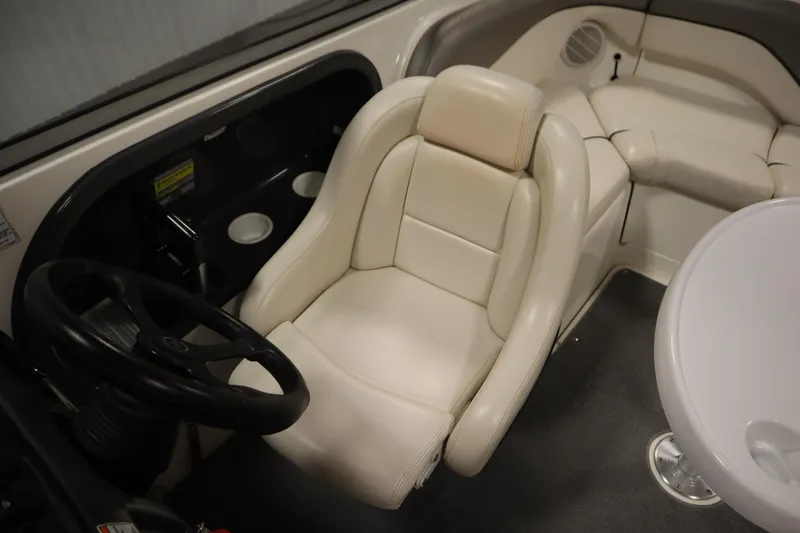 Slide: The Image of 2010 Yamaha 210 SX boat interior with white leather seating and steering wheel. - 28