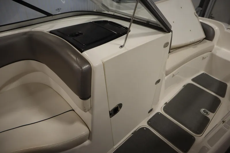 Slide: The Image of Interior of 2010 Yamaha 210 SX boat with seating and storage compartments. - 32