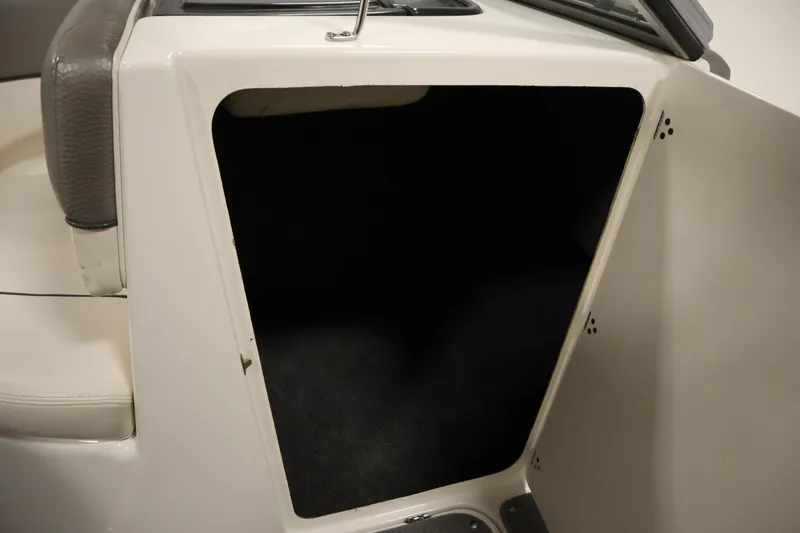 Slide: The Image of 2010 Yamaha 210 SX boat interior storage compartment with open door. - 34