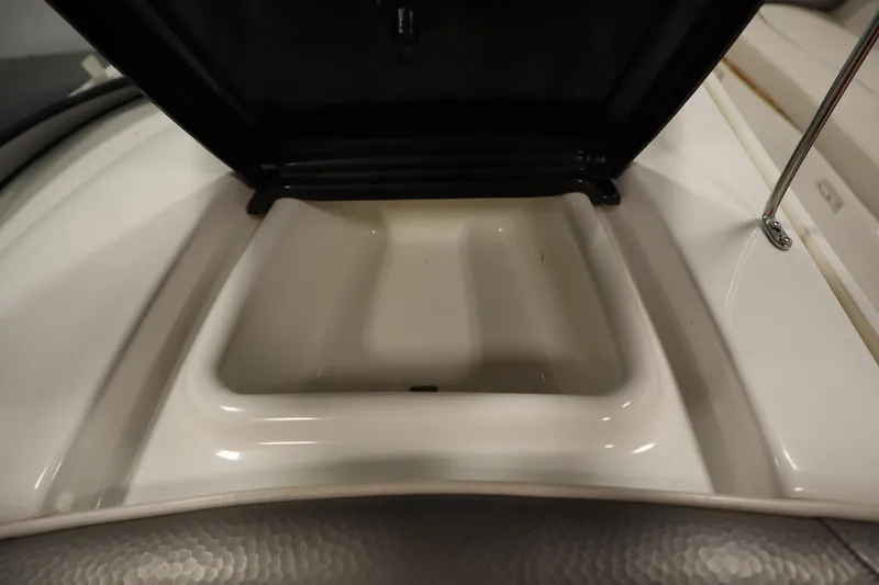 Slide: The Image of Open storage compartment on a 2010 Yamaha 210 SX boat. - 36